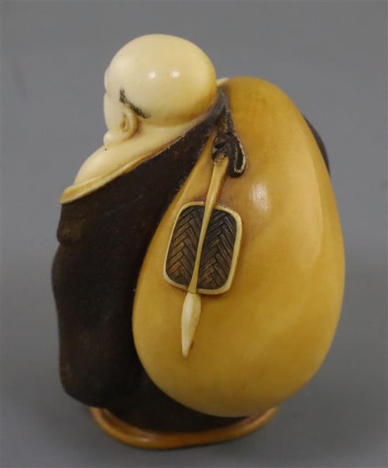 A Japanese ivory okimono netsuke of Hotei, early 20th century, H. 5.2cm